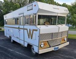 A vintage white and gold Winnebago motorhome